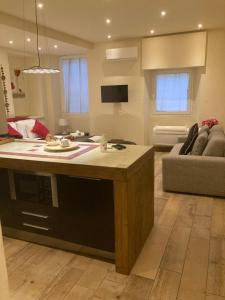 a kitchen and living room with a table and a couch at Borgo20 Firenze in Florence