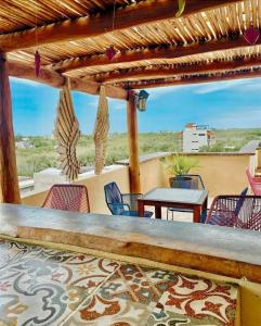 a patio with a table and chairs and a table and a table and chairsktop at Corazon Mexicano Holbox in Holbox Island
