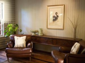 a living room with a couch and a chair at Solitaire Lodge in Rotorua