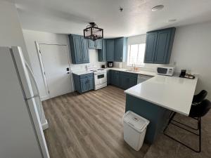 a kitchen with blue cabinets and a white counter top at Arch Canyon Inn in Blanding