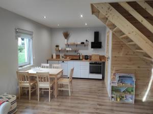 a kitchen and dining room with a table and chairs at Domek na Blejchu in Wisła