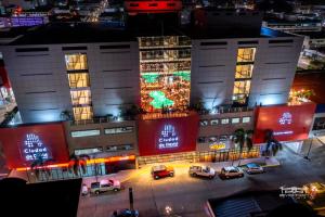 a building with cars parked in front of it at night at Hotel Ciudad de David in David