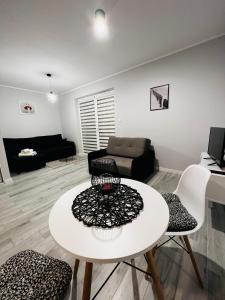 a living room with a white table and chairs at Apartment Comfort in Bartoszyce