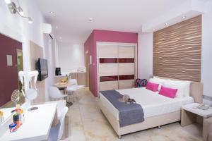 a hotel room with a bed and a desk at Loutsiana Deluxe Apts in Ayia Napa