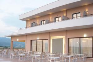 
a patio area with chairs, tables and chairs at Achillio Hotel in Komotini
