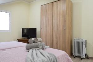 a bedroom with a bed with towels on it at Casa da Praia, a Home in Madeira in Ribeira Brava