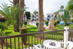 a view of the pool from the balcony of a resort at Loutsiana Deluxe Apts in Ayia Napa