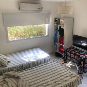 a small room with a bed and a window at Carpe Diem in La Paz +45 photos