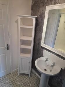 a white bathroom with a sink and a mirror at Hardwick Haven, Sedgefield - Near Hardwick Hall in Stockton-on-Tees