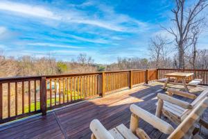 a deck with a picnic table and chairs on it at Smoky's Bunkhouse-VIEW! Hot Tub! Private! GSMNP in Sevierville