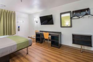 a bedroom with a bed and a desk and a tv at Motel 6-Abilene, TX in Abilene