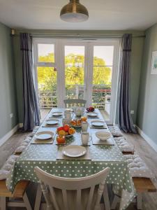 a dining room table with a polka dot table cloth at Marine House in Camber