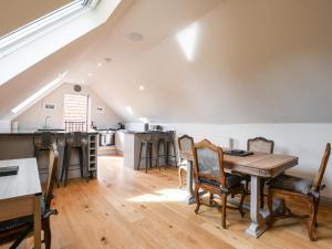 a kitchen and dining room with a table and chairs at The Cart Lodge in Ipswich
