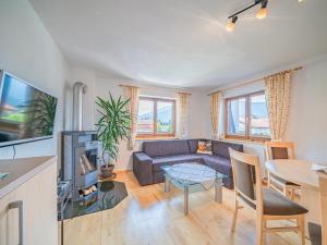 a living room with a couch and a table at Chalet Josef in Westendorf