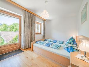 a bedroom with a bed and a large window at Haus Steger in Westendorf