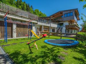 a yard with a playground in front of a house at Haus Steger in Westendorf