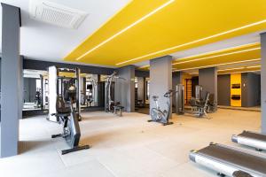 a gym with treadmills and cardio equipment in a building at Facto Bela Vista - Studios por temporada in Sao Paulo