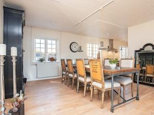 a kitchen and dining room with a table and chairs at 6 person holiday home in Skagen-By Traum in Skagen