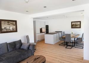 a living room with a couch and a table at AUSZEIT Apartments in Oberau