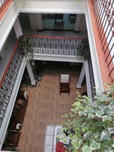 an overhead view of a room with a staircase and a plant at Hotel Castillo Real in Popayan