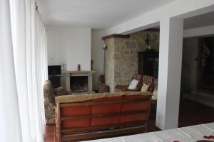 a living room with a couch and a fireplace at Casas do Corvo in Ventosa