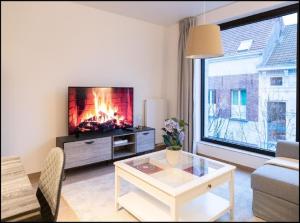 a living room with a fire place in the wall at OneLuxStay near Diamond District in Antwerp