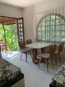 a dining room with a table and chairs at Pousada Chale Cana Brava in Guaramiranga