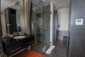 a bathroom with a sink and a glass shower at Siam@Siam Design Hotel Pattaya in Pattaya
