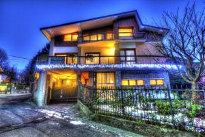 a house with lights in front of it at night at B&B dei Laghi in Magreglio