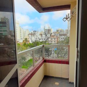 a balcony with a view of a city at Apartamento super arejado na Praia do Morro in Guarapari