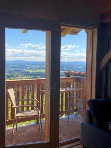 a balcony with two chairs and a view of the mountains at Winzerei Schober in Grubberg