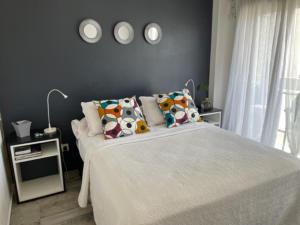 a bedroom with a large white bed with pillows at Studios Montevideo in Buenos Aires