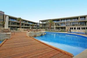 a swimming pool in front of a building at Resort Apartment 275 in Torquay