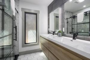 un bagno con due lavandini, una finestra e uno specchio di Casa Las Nubes NEW! Whatcom Lakefront Cabin/HotTub a Bellingham Altre 39 foto