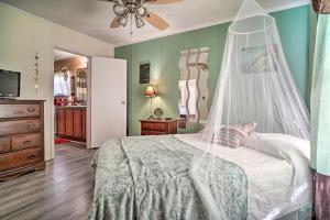 a bedroom with a bed with a mosquito net at Private Yard and Fire Pit Pet-Friendly Midway Abode in Midway