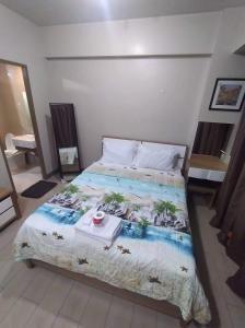 a bedroom with a bed with a breakfast on it at RQUI CONDOTEL NEWPORT PASAY in Manila