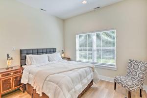 een slaapkamer met een bed, een raam en een stoel bij Cozy Tennessee Country Retreat on 5 Acres! in Pegram