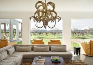 a living room with a couch and a chandelier at Lancemore Milawa in Milawa +34 photos