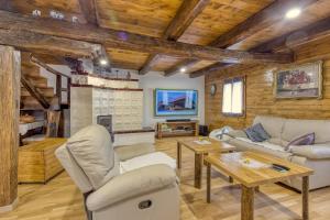 a living room with white furniture and a fireplace at Sustainable Wellness House Lina - Happy Rentals in Lopatinec