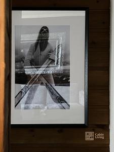 a framed picture of a woman holding two baseball bats at Nice apartment with Sauna and ski in out Trysil in Trysil