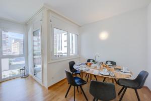 a dining room with a table and chairs at Casa Al Molo - Happy Rentals in Locarno