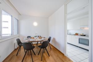 a kitchen and dining room with a table and chairs at Casa Al Molo - Happy Rentals in Locarno