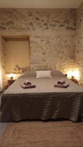 ein Schlafzimmer mit einem Bett mit zwei Handtüchern darauf in der Unterkunft Pyrrichos Stone House 