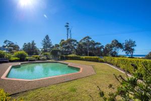 a swimming pool in the middle of a yard at Fathoms 6 in Mollymook