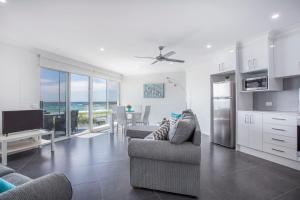 a kitchen and living room with a view of the ocean at Mariners 2 in Mollymook