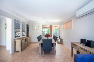 a dining room with a table and chairs at Leafy Retreat in Ulladulla