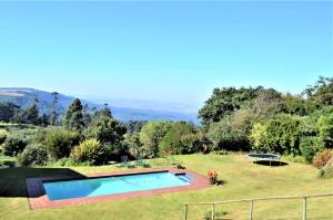 a garden with a swimming pool in the grass at Gateside Guesthouse in Hilton