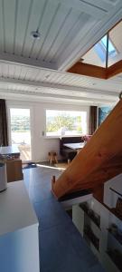a living room with a table and a piano at Tiny House mit Panoramablick, Pool & Kamin! in Jena