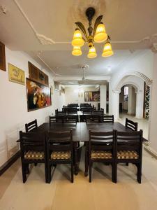 a dining room with a large table and chairs at The Ranthambhore Heritage in Sawāi Mādhopur