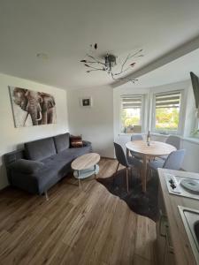 a living room with a couch and a table at Appartement Petra in Bruck an der Großglocknerstraße